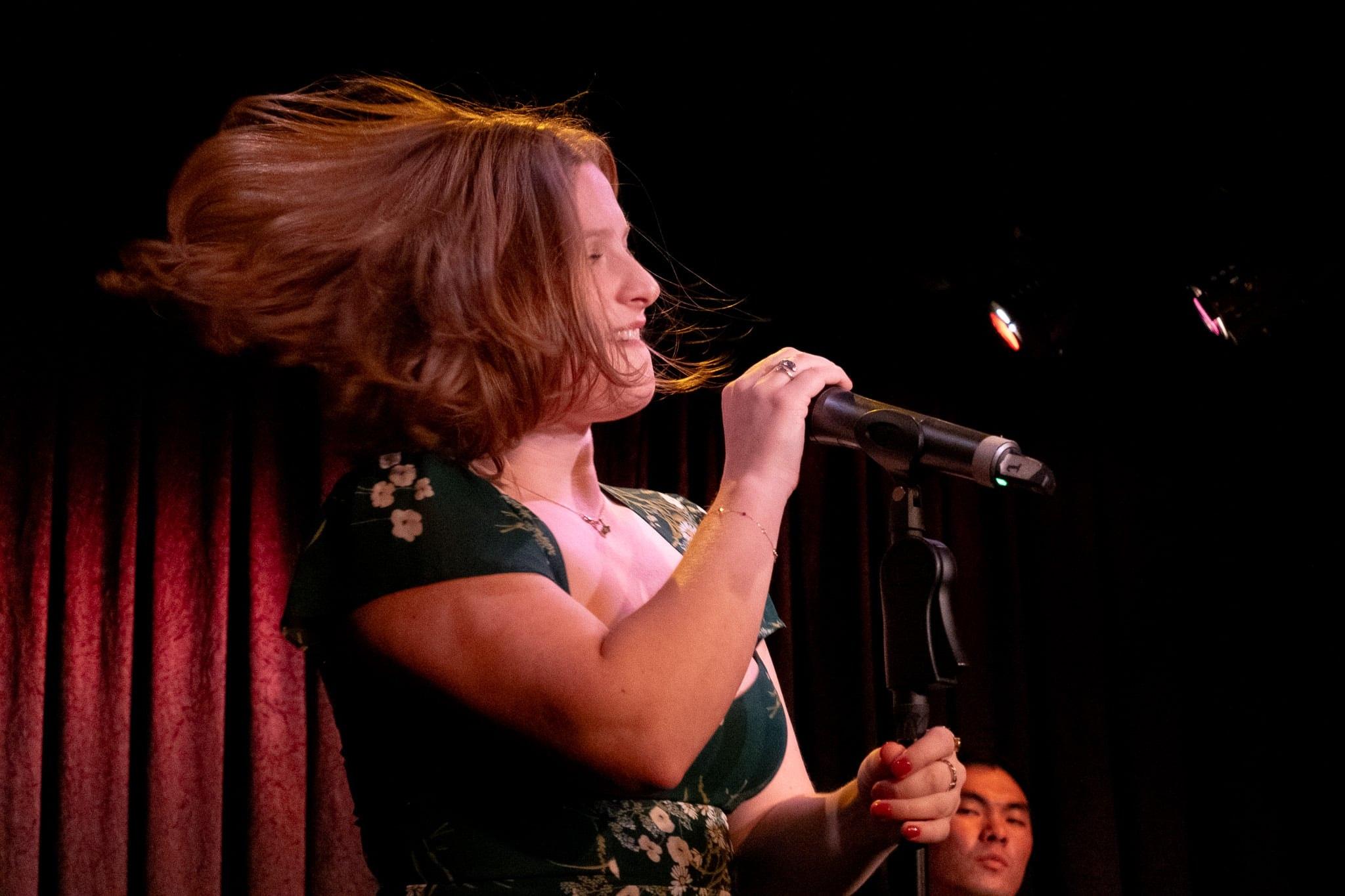 The singer’s hair flying as she spins at the microphone.