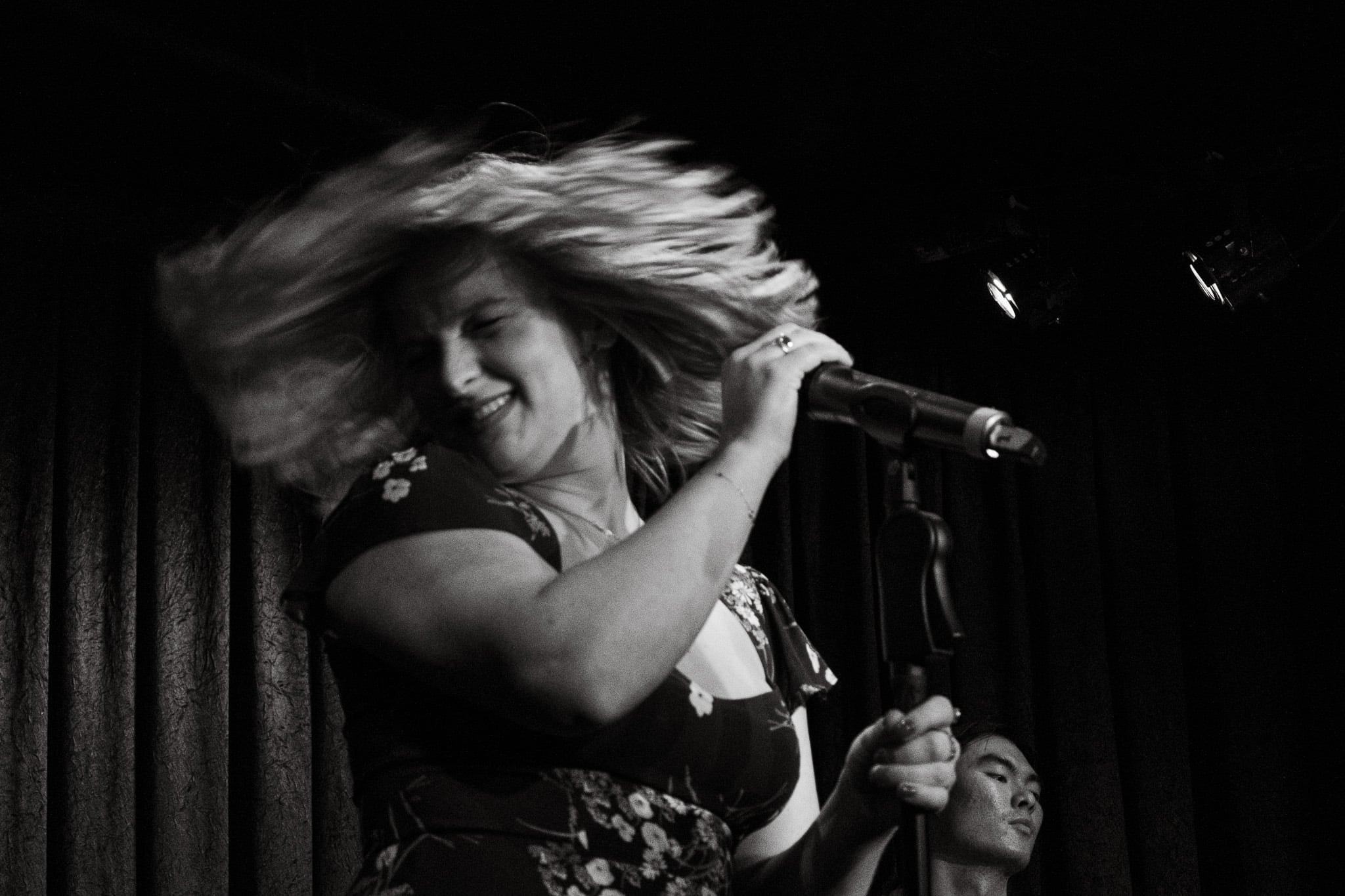 The same spin in black and white, a blur of hair.