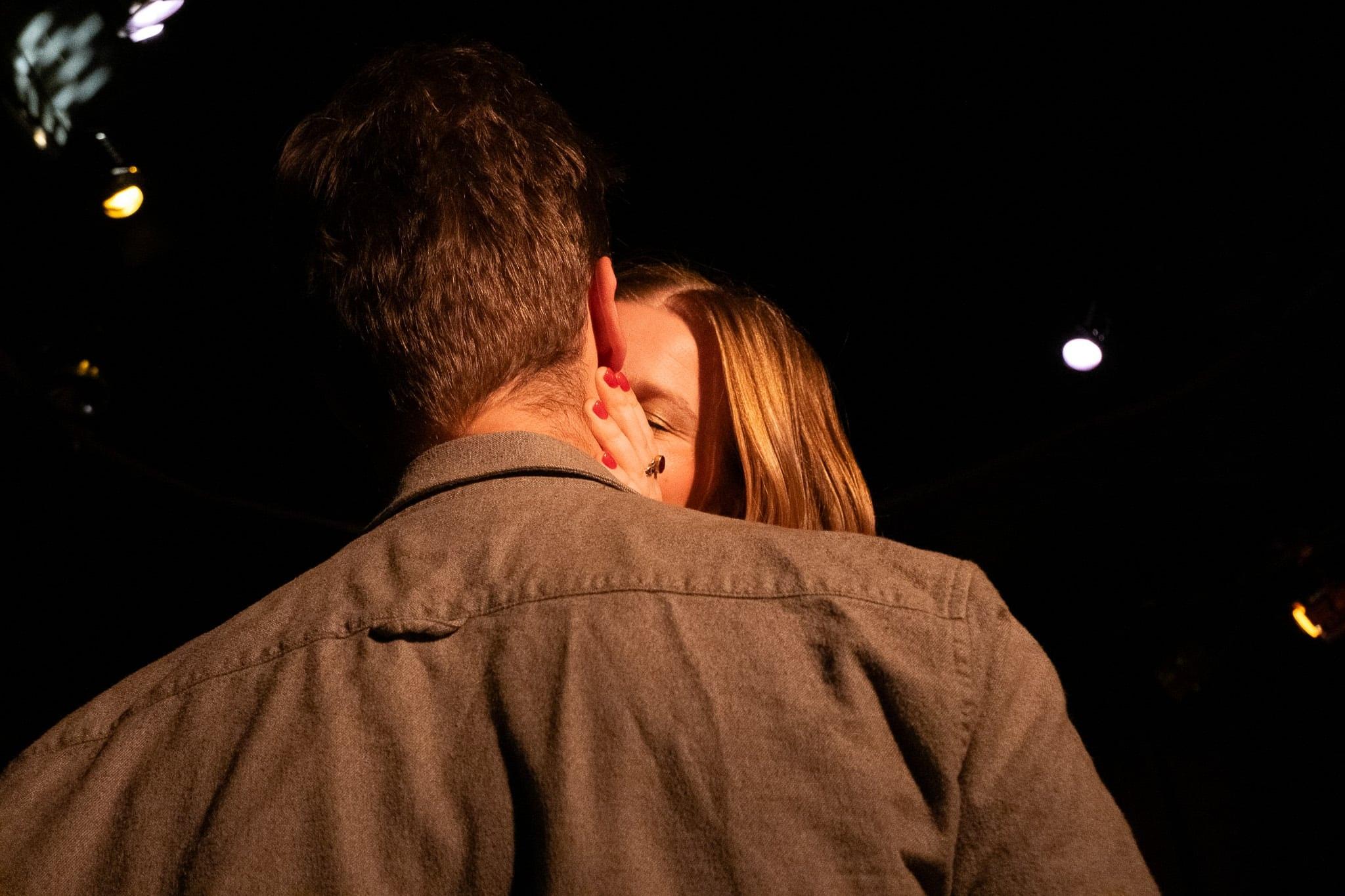 After the show: the singer hugging someone in a crowded, dim room.